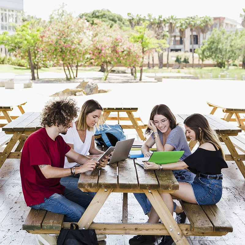 cheerful-friends-studying-table